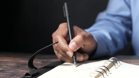 persona que escribe en un cuaderno