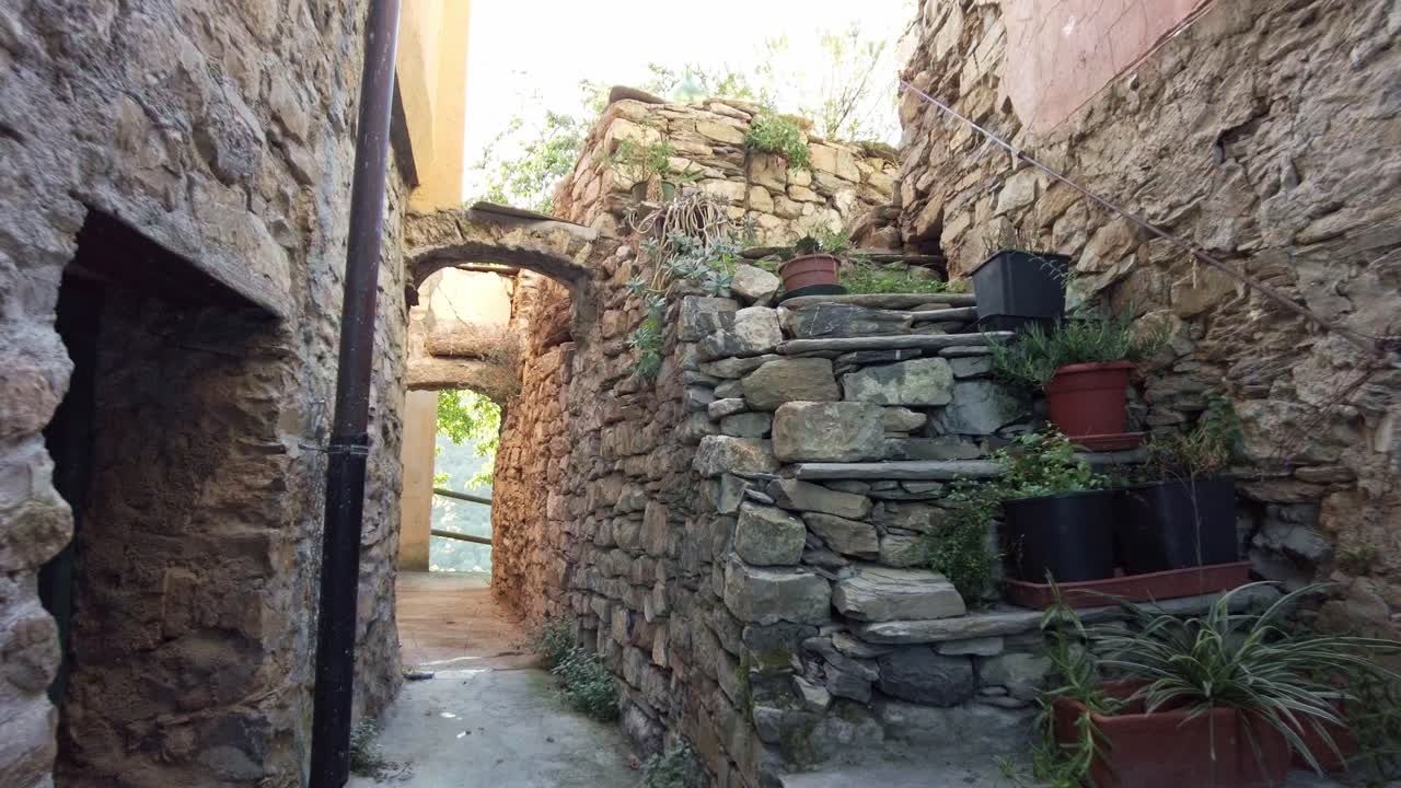 Old italian alley made from stone with sunset in the background