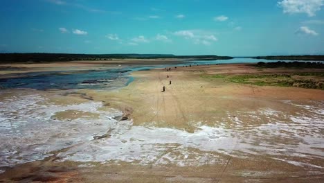 motorbikes driving along the active salt lake of lake magadi in the rift valley, kenya