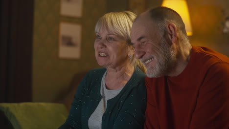 elderly couple watching tv