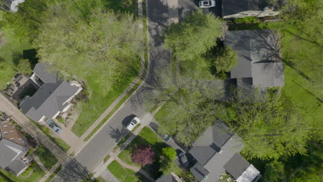 aerial with clockwise spin over suburban houses and street in st