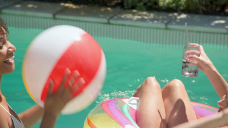 african american woman relaxing on colorful pool float, enjoying sunny day