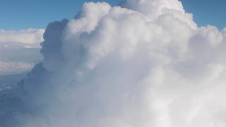 Passing by a large cumulus cloud — Aerial.