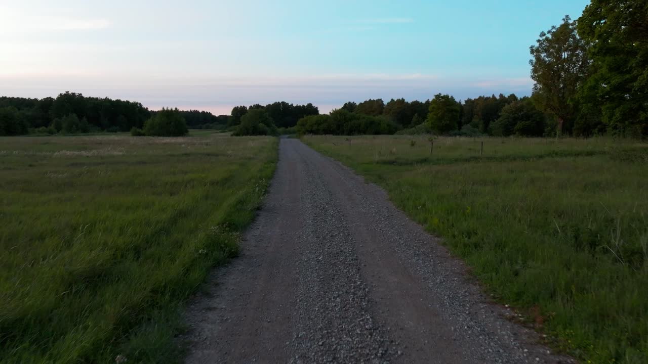 Moving on a gravel country road during evening light.