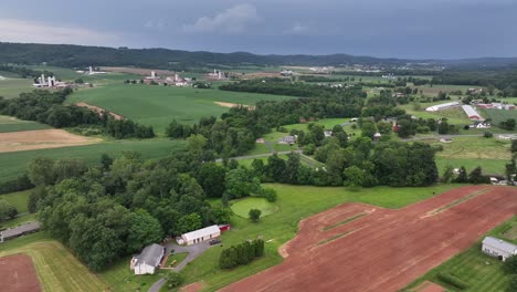 hills landscape of american countryside in summer season. aerial wide shot. picturesque scenery of farmsteads in nebraska, usa. street of suburb neighborhood