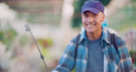 Cheerful-Farmer-Spraying-Herbicide-At-Farm-2