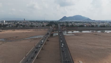 panoramic view of a busy bridge with on-going traffic over krishna river dried in vijayawada.
