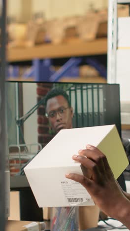 vertical video warehouse clerk meeting on web video call with manager on computer