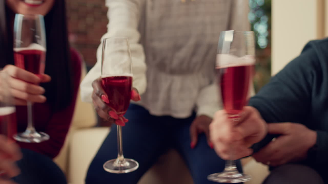 Office employees clinking glasses of wine at christmas party