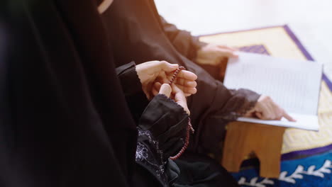 portrait of an asian muslim women in a daily prayer at home reciting surah al-fatiha passage of the qur'an in a single act of sujud called a sajdah or prostration