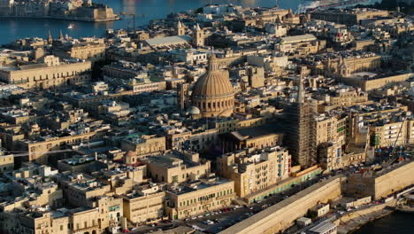 Aerial-view-around-the-Basilica-of-Our-Lady-of-Mount-Carmel,-Valletta,-golden-hour-in-Malta