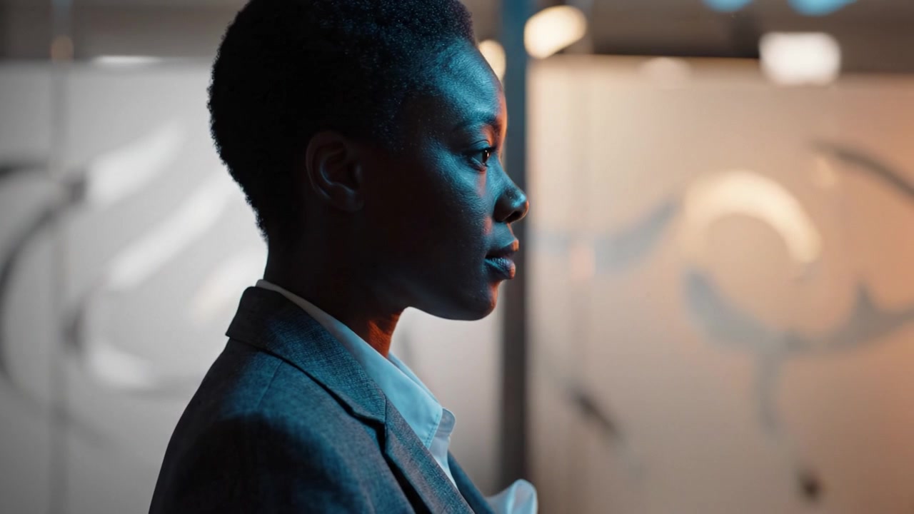 A Professional Woman in Profile: This video captures the confident demeanor and poised presence of a businesswoman, highlighting her strength and determination.