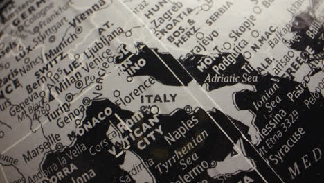close-up of a monochrome globe showing italy and neighboring european countries