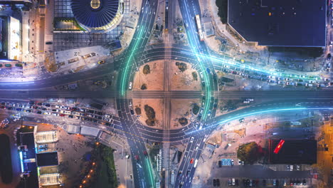 Top-down-hyperlapse-shot-of-traffic-on-large-road-intersection.-Visual-effect-highlighting-traces-of-vehicles.-Rondo-Romana-Dmowskiego,-Warsaw,-Poland