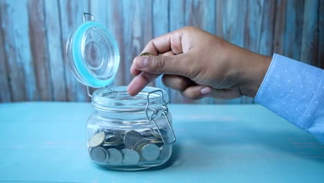 saving coins in a glass jar