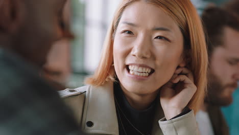 beautiful asian woman chatting with friend in cafe laughing enjoying conversation hanging out in restaurant socializing