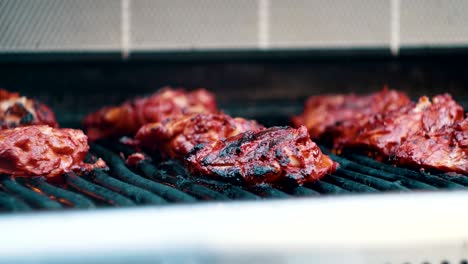 tandoori chicken cooking on a bbq grill.