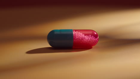 extreme macro close up of medical bicolour drug pill red and blue for medical treatment of disease , pharmaceutical industry