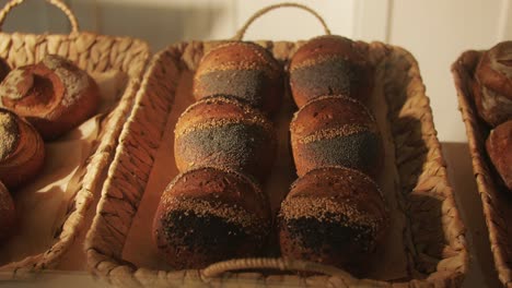 fresh artesian bread on bakery shop close-up. bread with black poppy garnish on top and white flour on top. artisan bread is making by skill bakers using natural and high-quality ingredients. food with health and flavour benefits.
