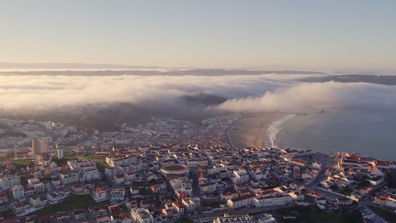 ciudad costera de nazare, portugal, costa de la plata, con nubes bajas al amanecer, aero