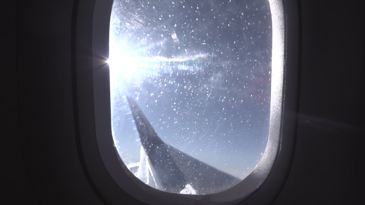 View from an airplane window of the sun shining
