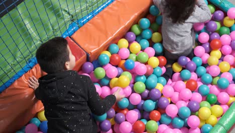 happy children playing together and having fun at kindergarten with colorful balls. 5-6 years old