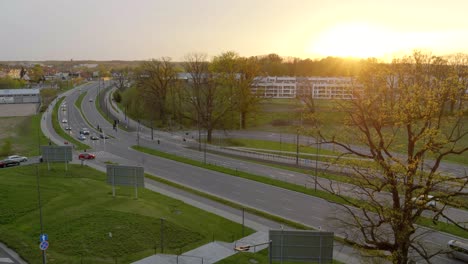 cars driving on a two-lane road at sunset