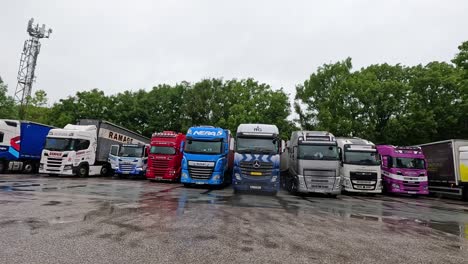 trucks parked in a lot under cloudy skies