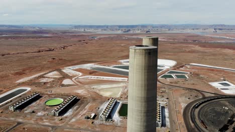 A-drone-shot-of-the-“Navajo-Generating-Station”,-a-massive-coal-fired-power-plant-and-industrial-complex-with-tall-stacks,-in-the-middle-of-the-desert-of-the-Navajo-Nation,-located-near-Page,-Arizona