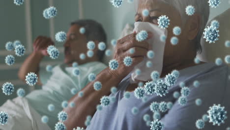 animation of covid 19 cells over senior couple in bed, woman sneezing