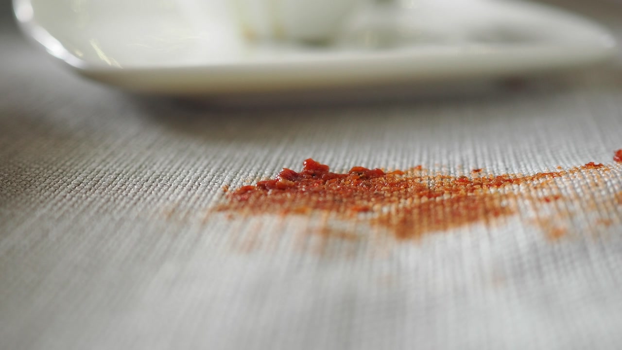 Close-up of a Red Food Stain on a White Tablecloth