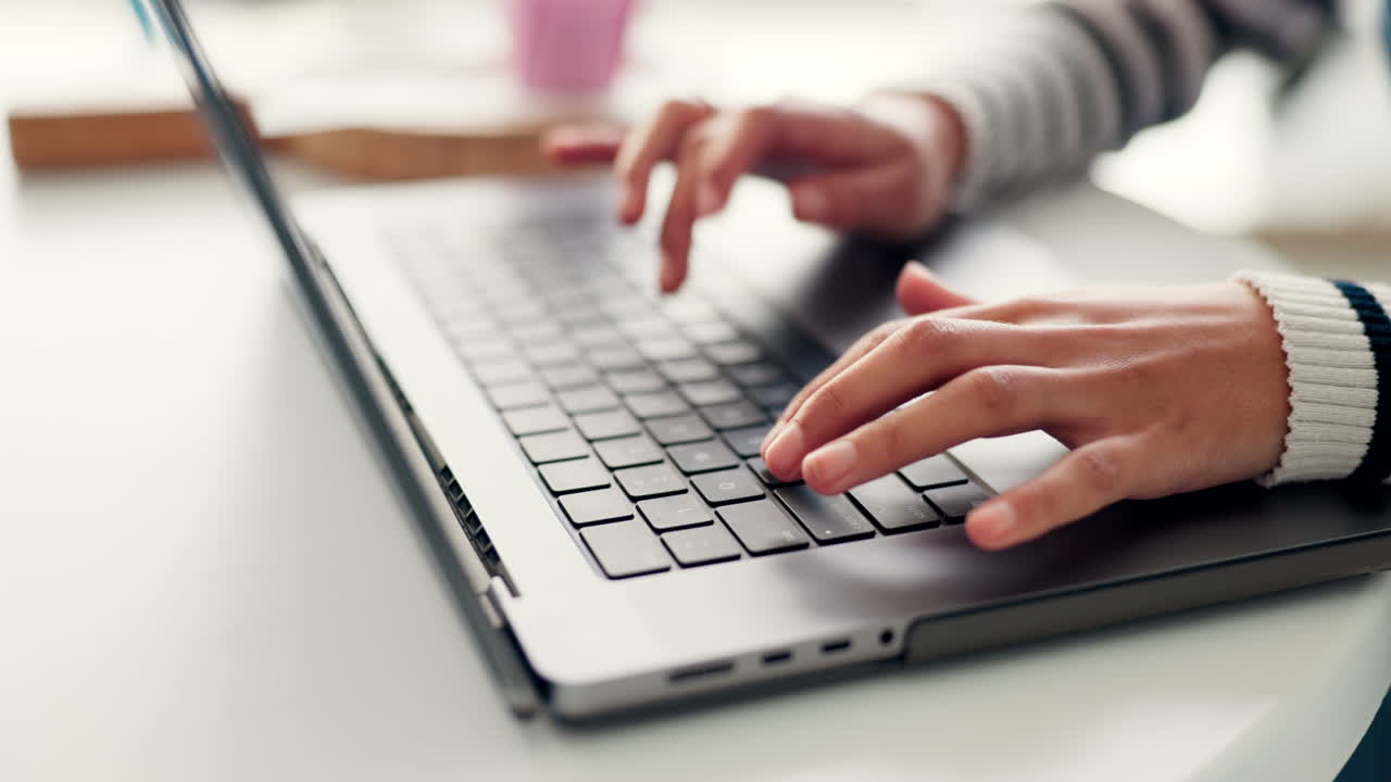 Person, hands and typing on laptop keyboard