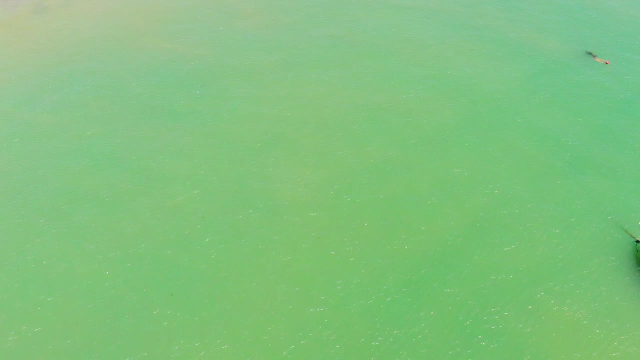 Drone over the sea passing by three fishing boats in a green sea. Itapuã Bahia Brazil