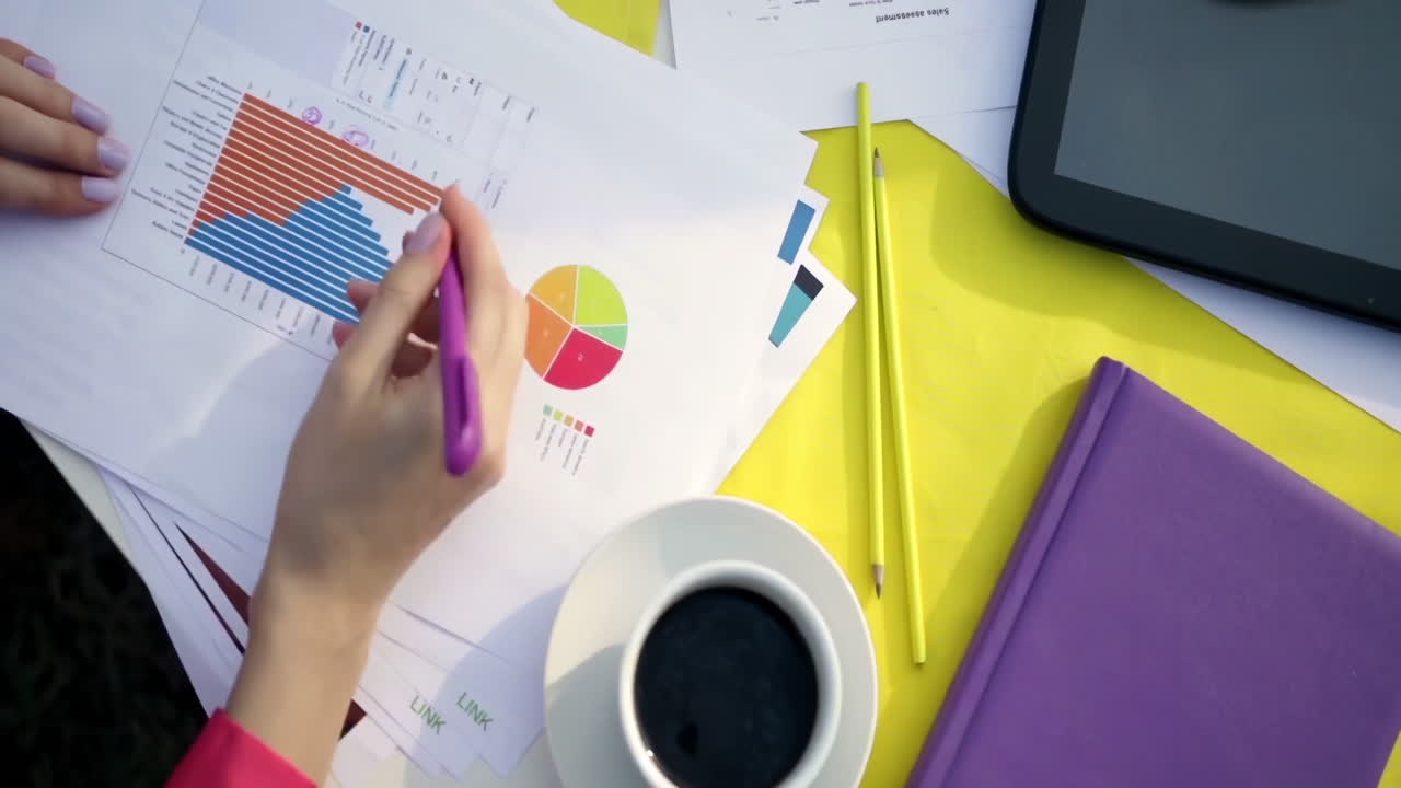 A business team brainstorming ideas analyze sales reports in a modern office, showcasing their focus, collaboration, and use of digital and printed materials