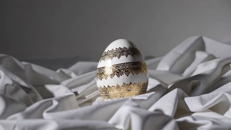 ornate white easter egg on white fabric