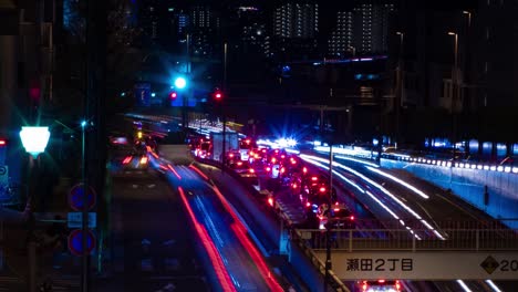 a night timelapse of the traffic jam at the city street in tokyo long shot