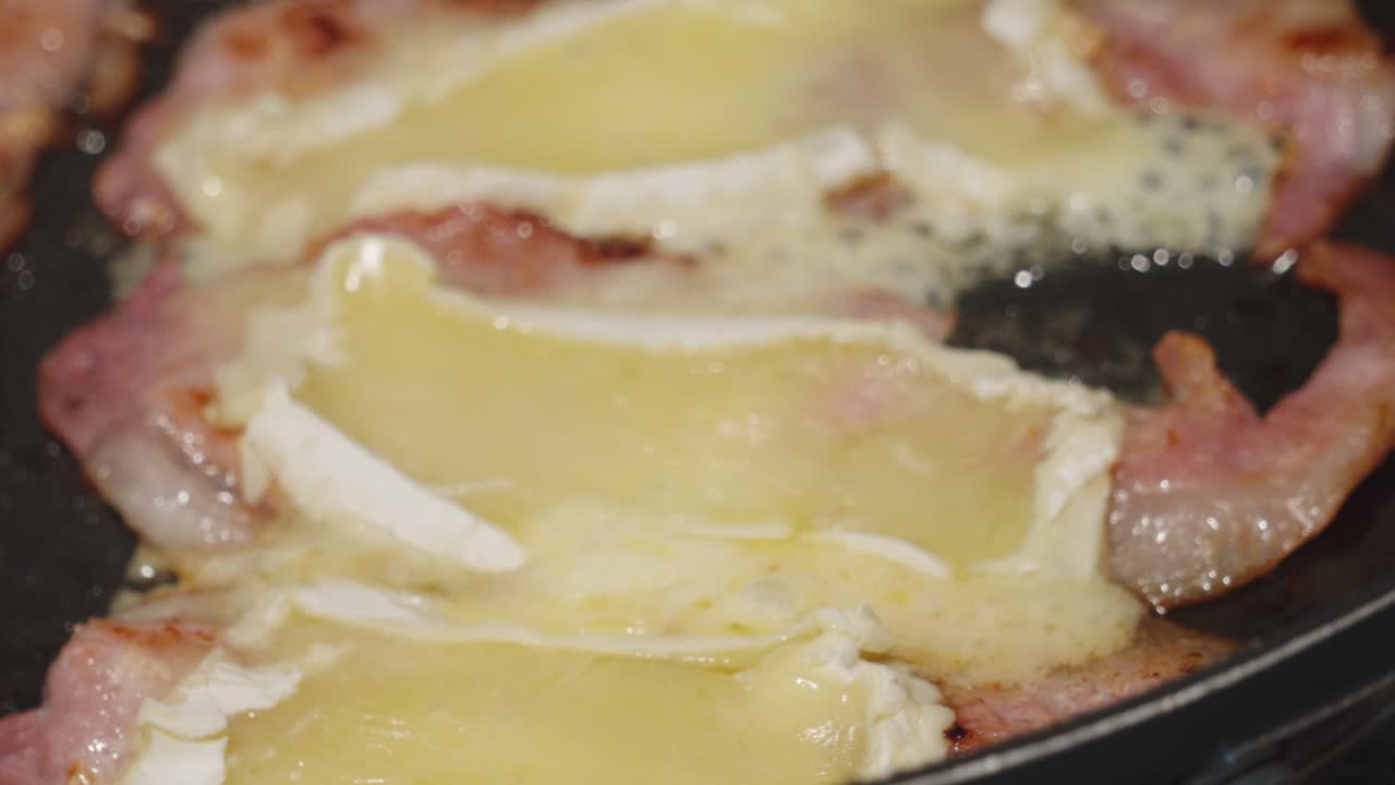 Bacon and Brie in Hot Frying Pan Cheese Melting on Top Ready to be Placed in Sandwich or Baguette. Indulgent Delicious Lunch Snack Meal. Unhealthy High Calorie Hot Cooking Food.