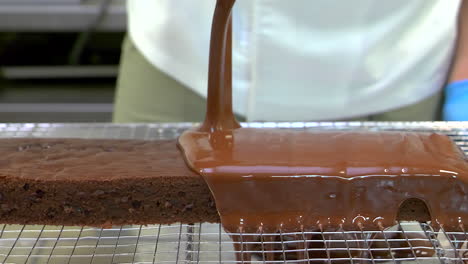 liquid chocolate falling on a brownie