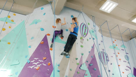 mother and daughter rock climbing