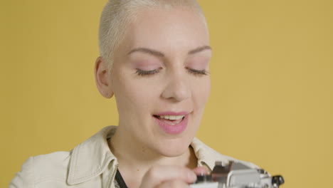 smiling woman takes photograph on vintage camera 01