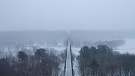 spectacular symmetrical, aerial view of the arcola high bridge during heavy snowfall