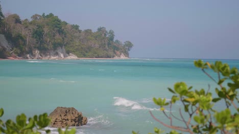 a windy day on an island with turquoise sea water and waves