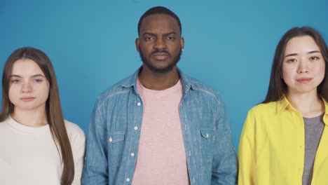 Young-black-man-and-his-friends-Portrait-of-Asian-young-woman-and-european-young-woman.