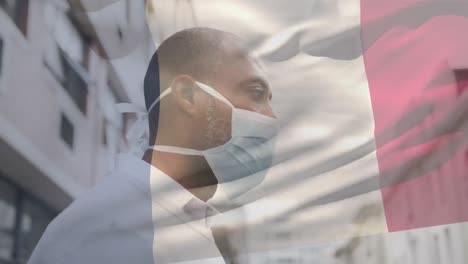 Animación-De-La-Bandera-De-Francia-Ondeando-Sobre-Un-Hombre-Con-Mascarilla-Durante-La-Pandemia-De-Covid-19