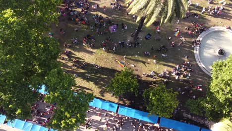 drone view above crowded park of buenos aires, during the lgbtqia+ pride parade - birds eye, drone shot