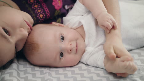 Young-woman-embrace-baby.-Portrait-of-sweet-baby-in-sister-embrace