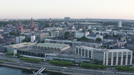 aerial circling drone view of mainz dom, rheingoldhalle, river rhine and cityscape at sunset germany 4k