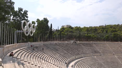 historic stadium with olympic rings and seating