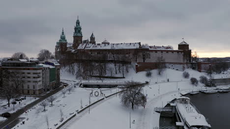 snow-covered wawel castle at cloudy morning, krakow, poland