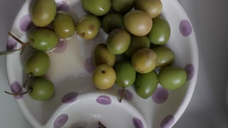 green and yellow olives on a polka dot plate, fresh and traditional de campo real